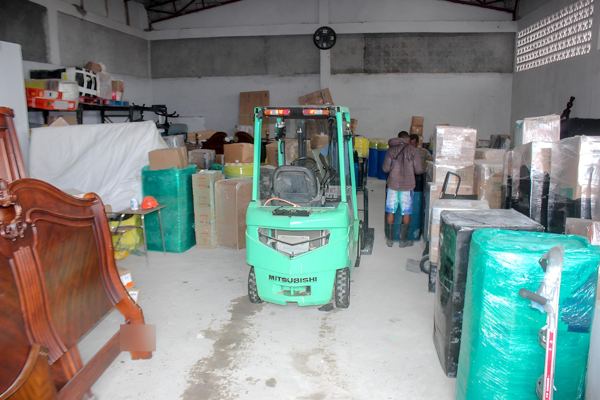Inside the warehouse, shipments sorted along the aisle