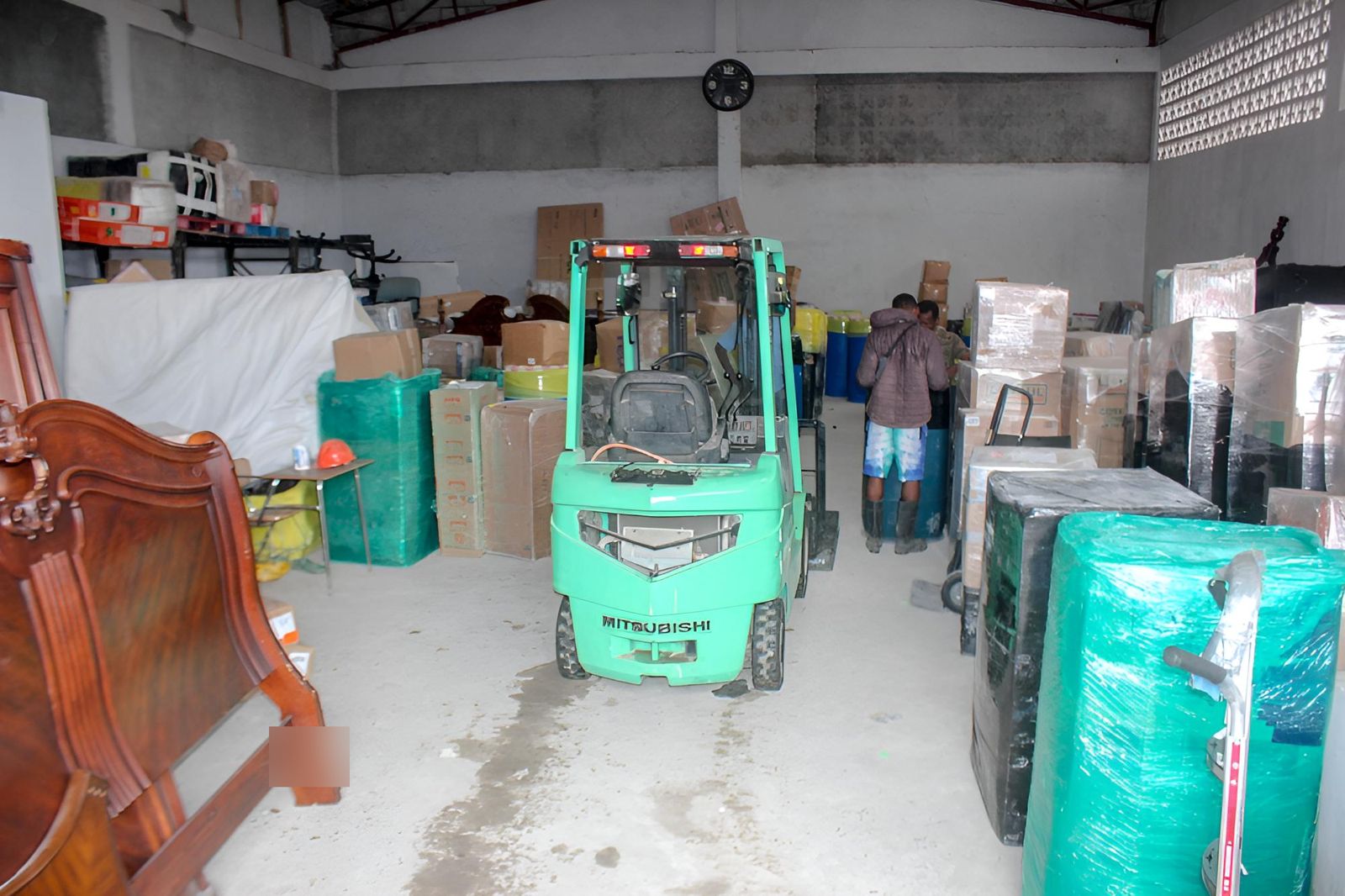 Inside the warehouse, shipments sorted along the aisle