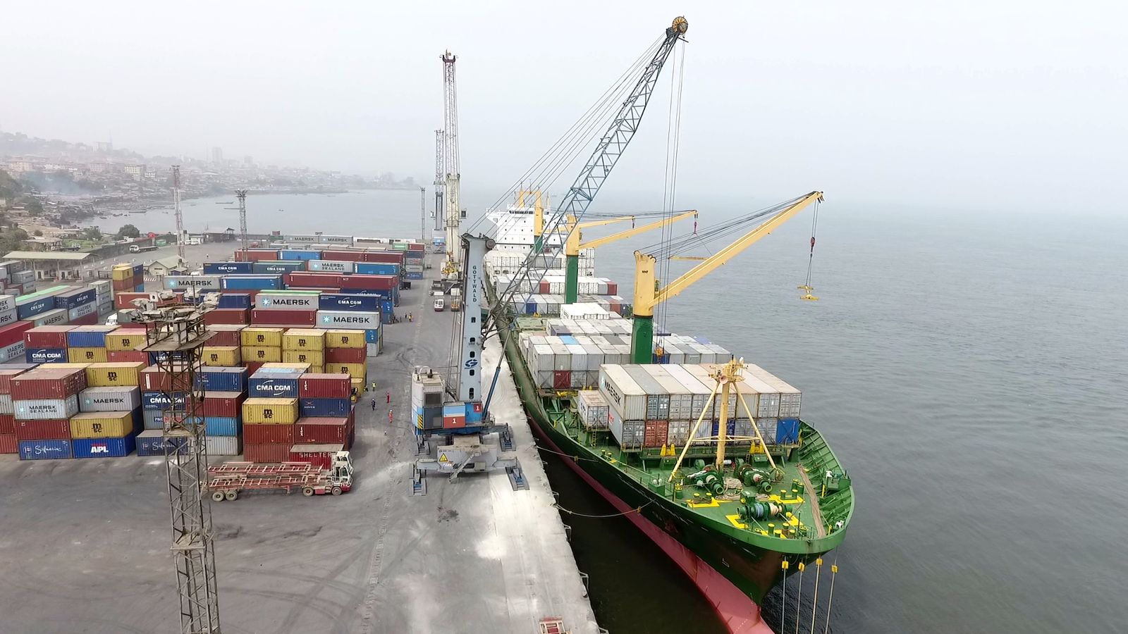 Cranes unloading a container ship at the Port of Freetown
